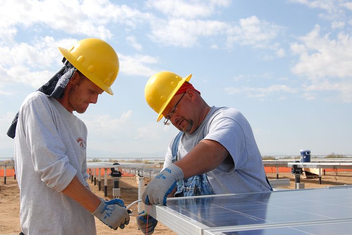 Two workers providing solar panel financing